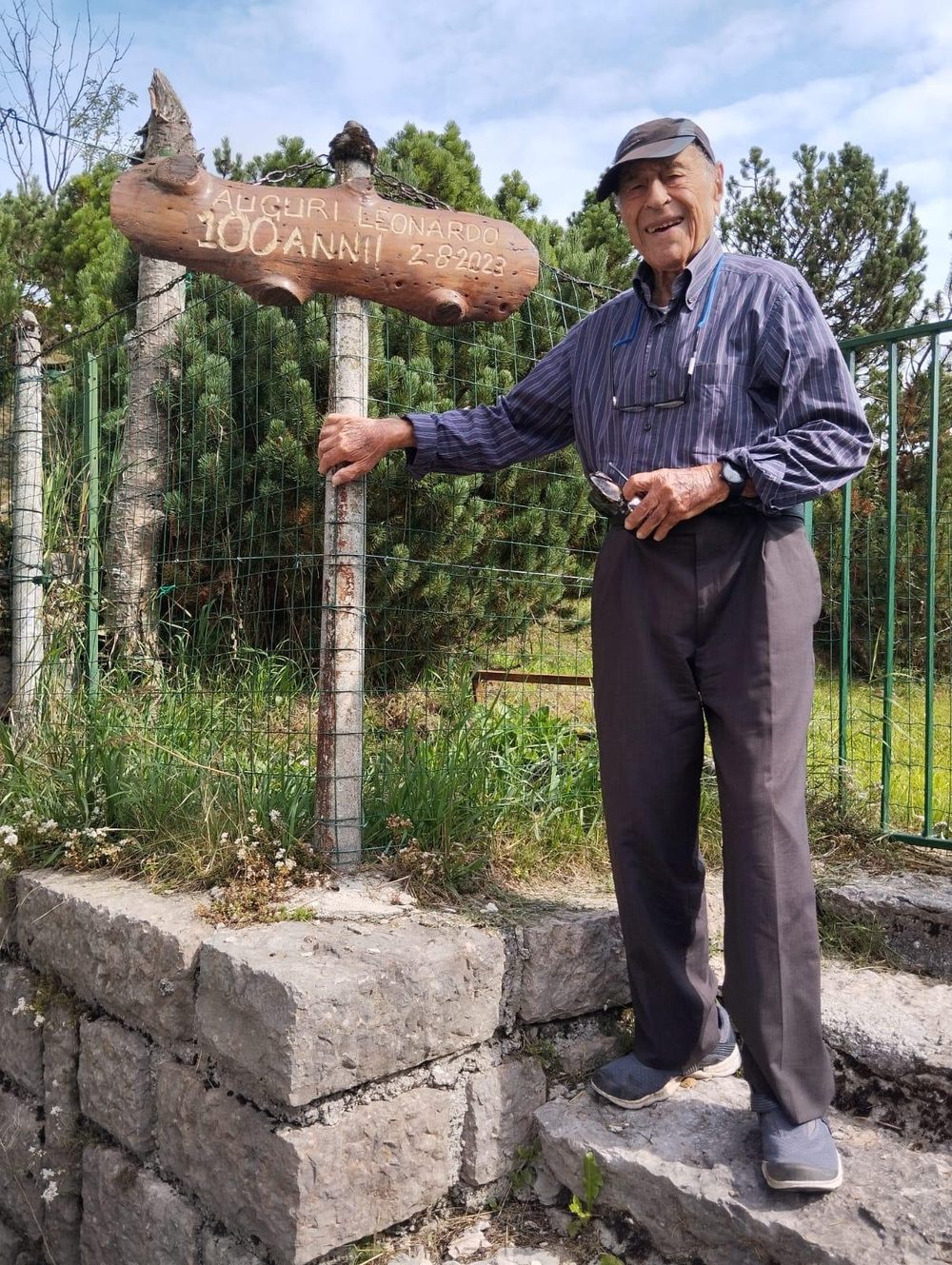 Il dott. Leonardo Maiuri accanto al cartello in legno «Auguri Leonardo 100 anni»